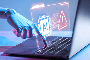 A robotic hand types on a laptop keyboard.