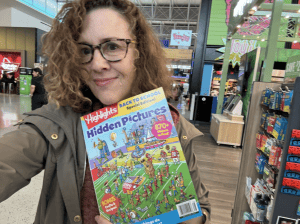 AI trainer Shana Burg holds Highlights Magazine in an airport